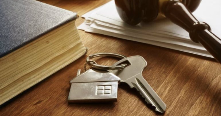 Photo of keys, books, and legal documents