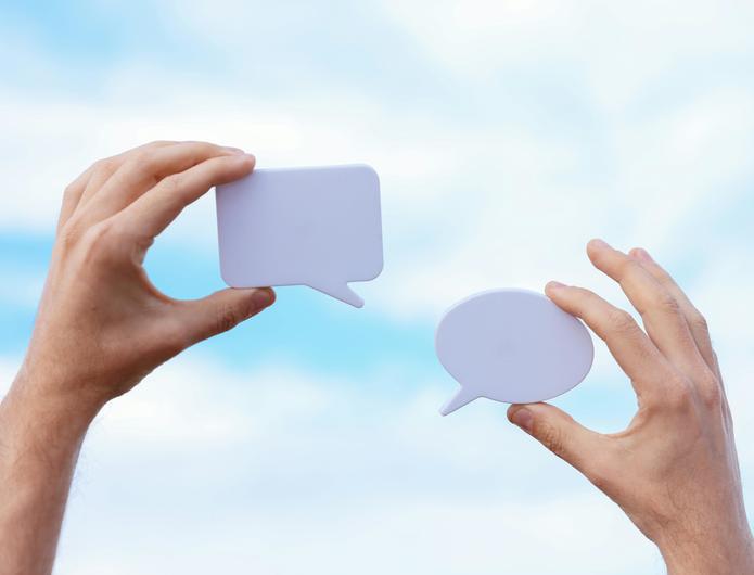 Photo of hands holding speech bubbles